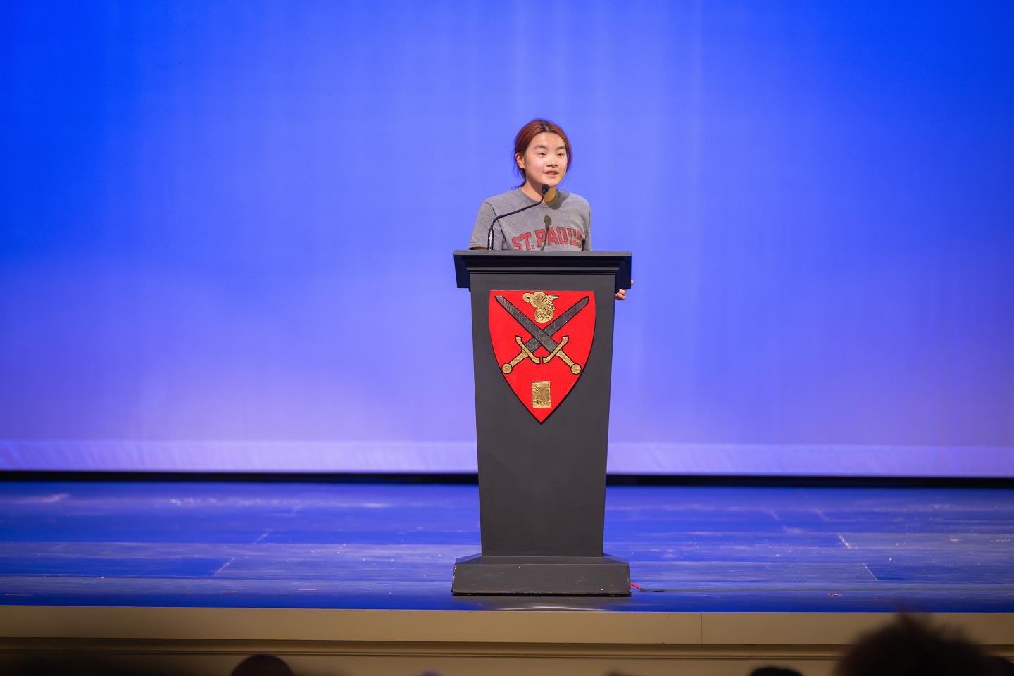 Alice Qi '28 on stage in Memorial Hall during the annual Hugh Camp Cup speaking competition.