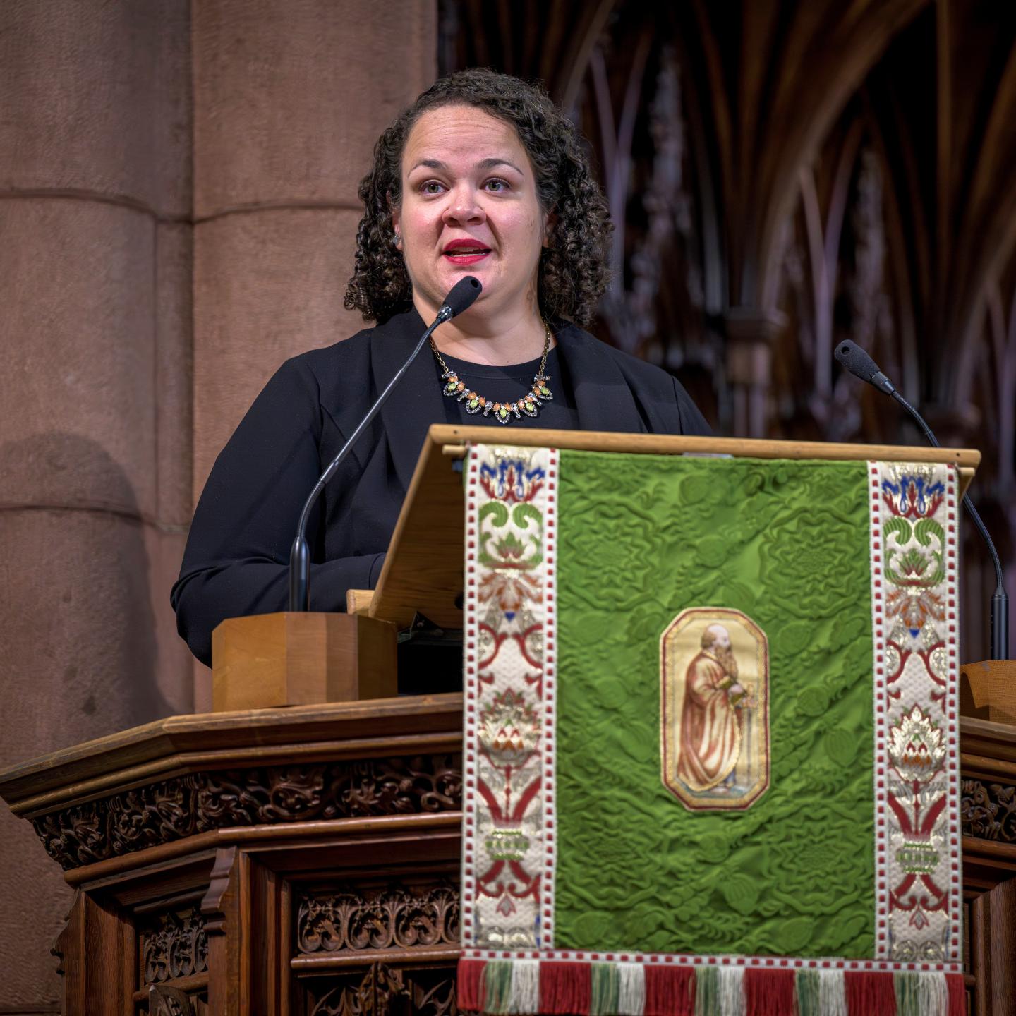 Diana Caba '01 speaking in chapel