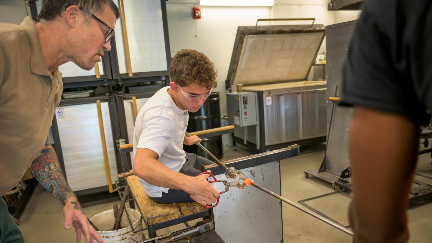 Jack Bretl in glassblowing class