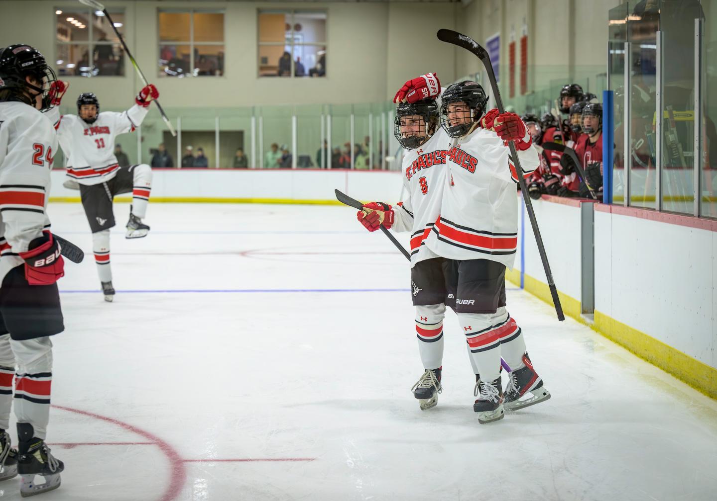 Boys Varsity Hockey players celebrate a goal in their game against Groton on Nov. 27, 2023.